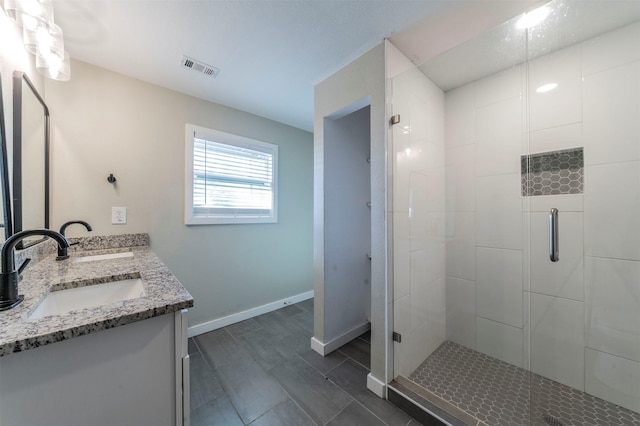 bathroom with vanity and an enclosed shower