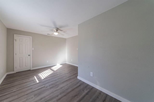 spare room featuring hardwood / wood-style floors and ceiling fan