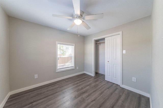 unfurnished bedroom featuring dark wood-type flooring, ceiling fan, and a closet