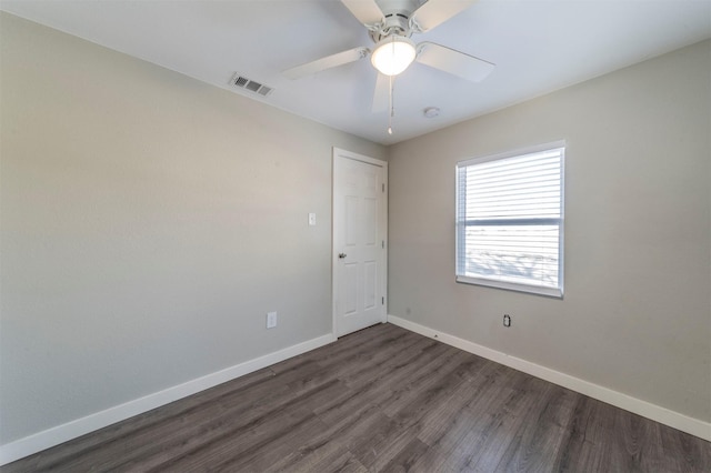 spare room with ceiling fan and dark hardwood / wood-style floors