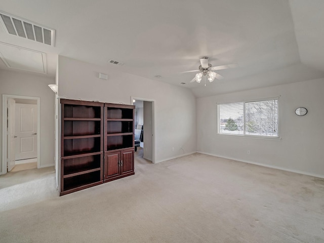 interior space featuring light carpet, vaulted ceiling, and ceiling fan