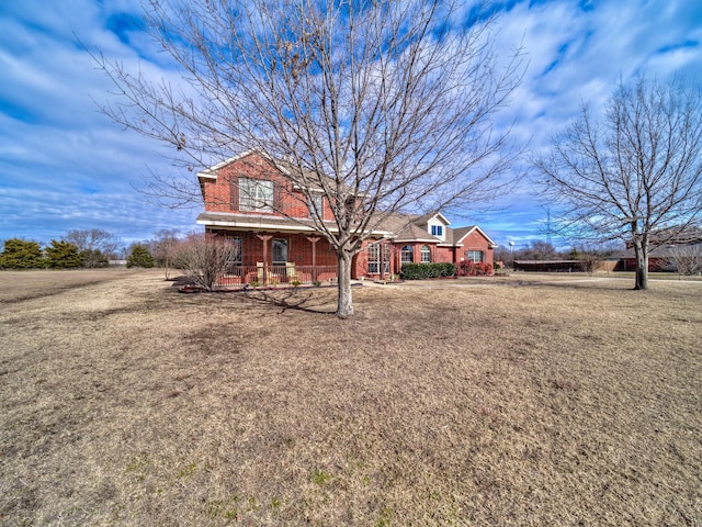 view of front facade with covered porch and a front lawn