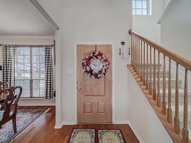 foyer with hardwood / wood-style flooring, ornamental molding, and a healthy amount of sunlight