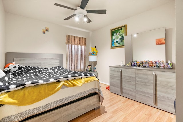 bedroom with light hardwood / wood-style floors and ceiling fan