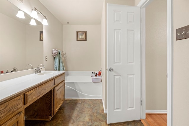 bathroom with vanity and a tub