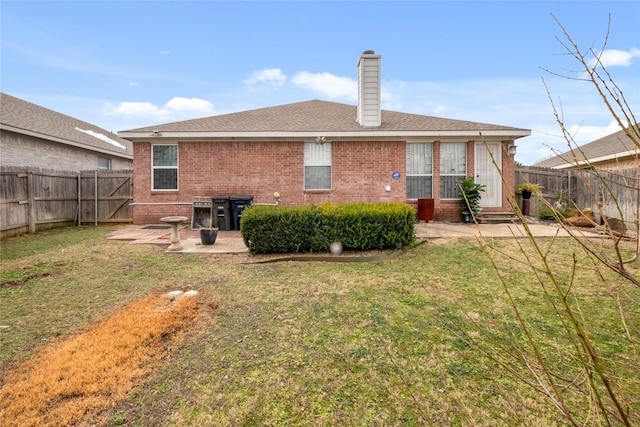 rear view of property featuring a patio area and a lawn