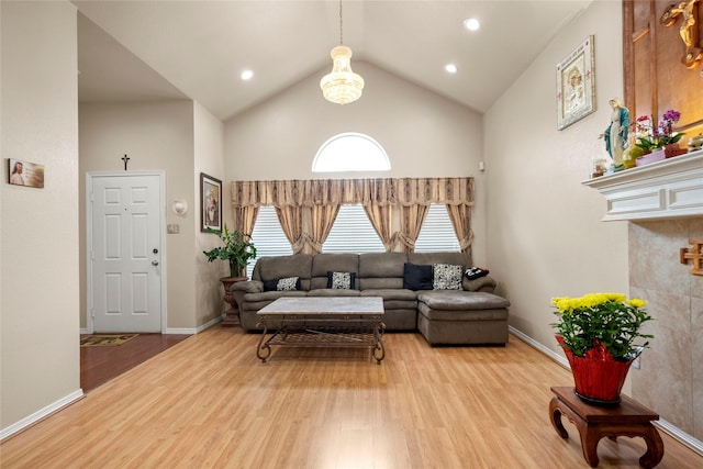 living room with hardwood / wood-style flooring and high vaulted ceiling