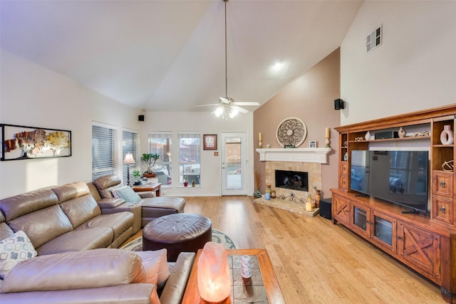 living room featuring ceiling fan, high vaulted ceiling, and light hardwood / wood-style floors