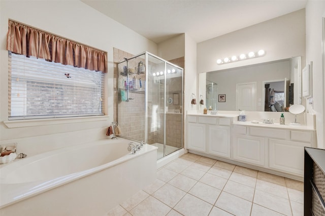 bathroom with tile patterned flooring, vanity, and separate shower and tub