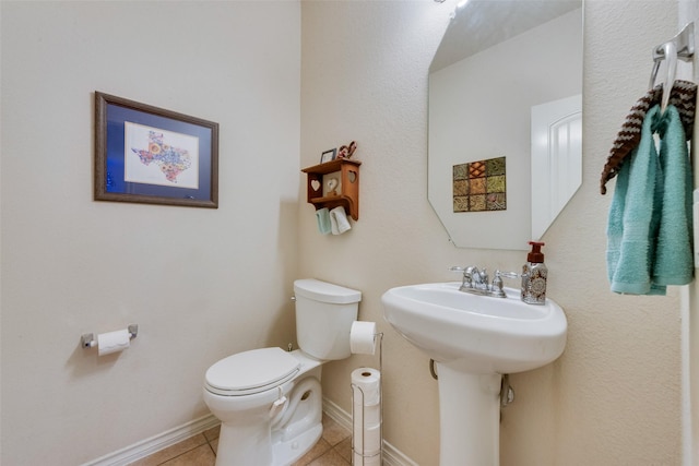 bathroom featuring toilet and tile patterned flooring