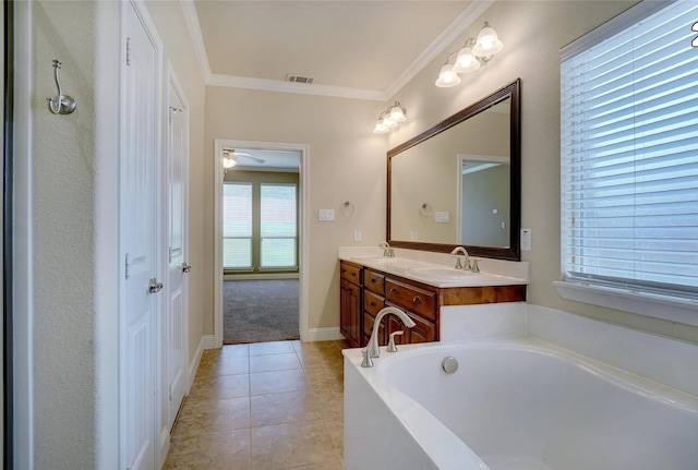 bathroom with a washtub, vanity, tile patterned flooring, and ornamental molding