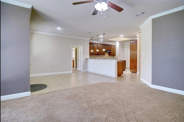 unfurnished living room featuring sink, crown molding, light tile patterned floors, and ceiling fan