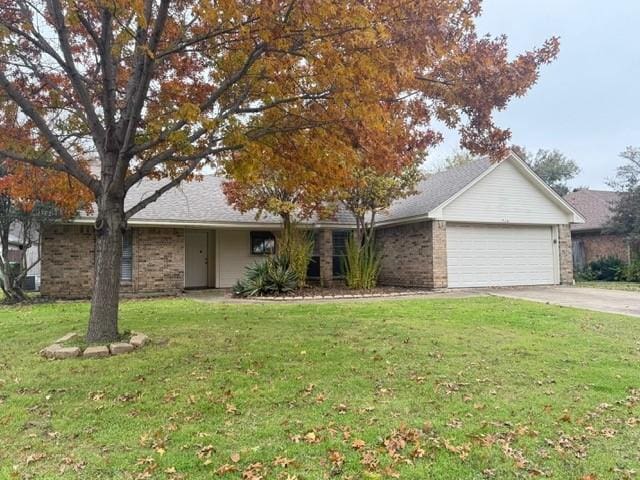 ranch-style house with a garage and a front yard