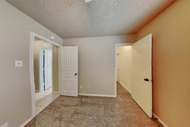 unfurnished bedroom with light carpet and a textured ceiling