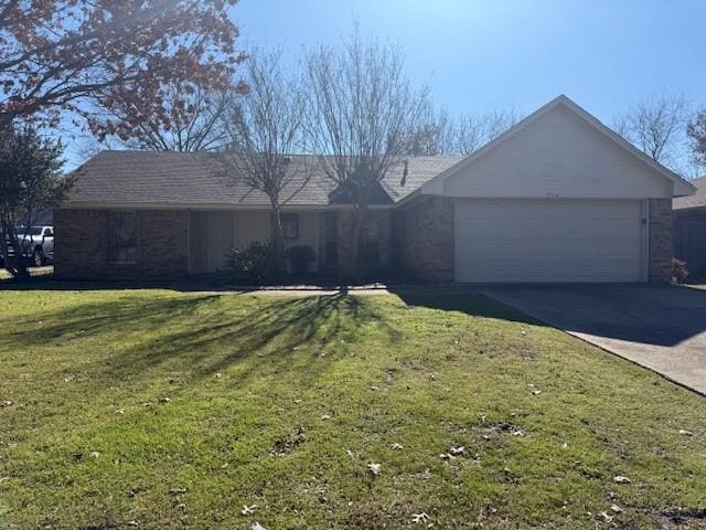 ranch-style house featuring a garage and a front lawn