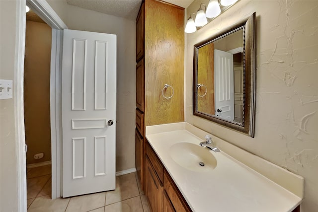 bathroom with vanity, tile patterned floors, and a textured ceiling