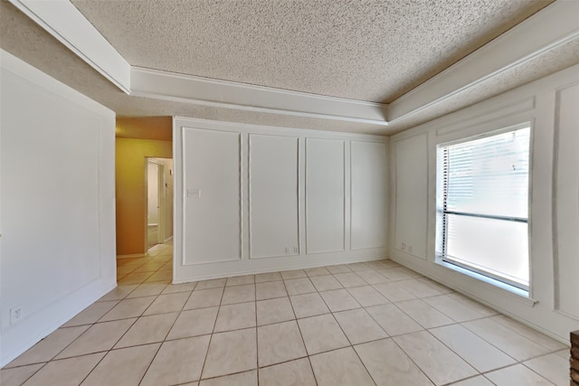 tiled spare room featuring a textured ceiling