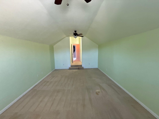 bonus room with light colored carpet and lofted ceiling