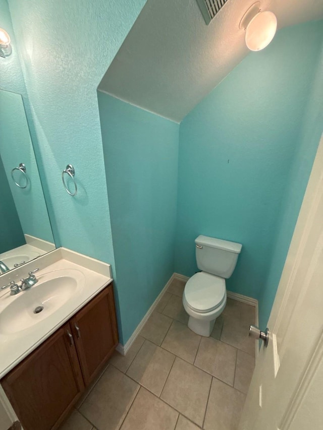 bathroom featuring tile patterned flooring, vanity, and toilet