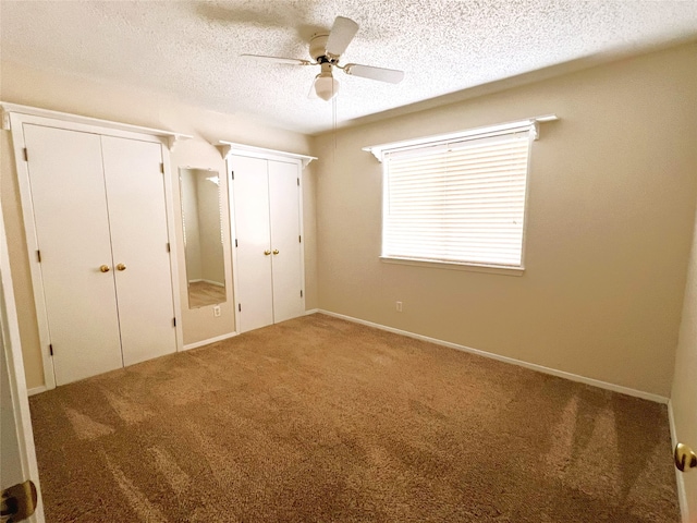 unfurnished bedroom with ceiling fan, carpet flooring, and a textured ceiling