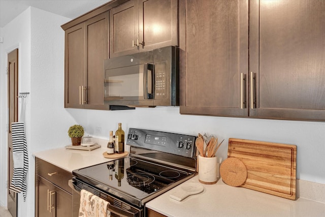 kitchen with black appliances and light countertops