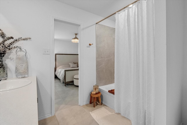 ensuite bathroom featuring shower / tub combo, tile patterned flooring, connected bathroom, and vanity