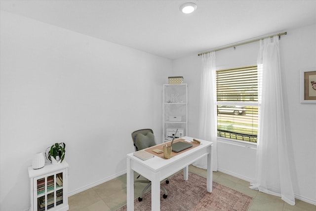 home office featuring light tile patterned floors and baseboards