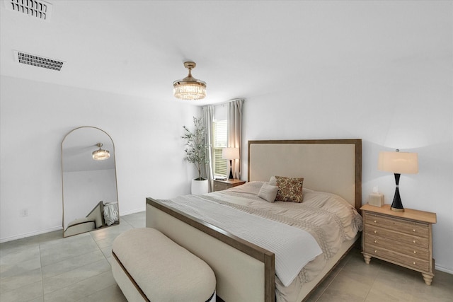 bedroom featuring light tile patterned floors, visible vents, and baseboards