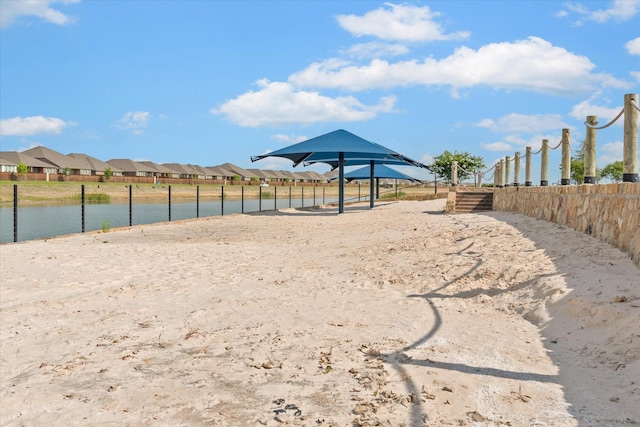 view of yard featuring a water view and fence