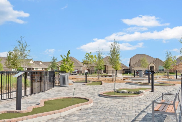 view of property's community with fence and a residential view