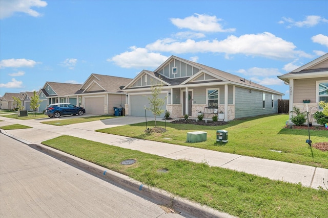 craftsman inspired home featuring a garage, a front yard, and covered porch