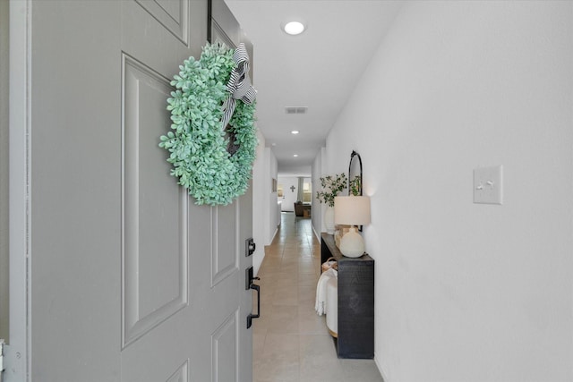 corridor featuring recessed lighting, visible vents, and light tile patterned floors