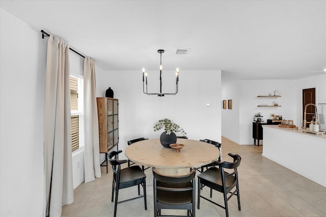 dining space featuring visible vents and a notable chandelier