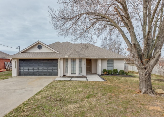 ranch-style house featuring a garage and a front yard