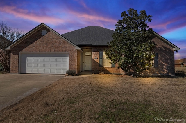 view of front of home featuring a garage and a yard