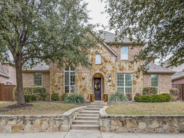 tudor-style house featuring a front yard