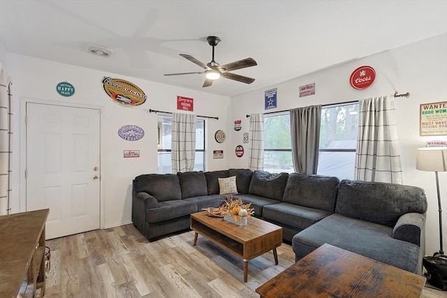 living room with light hardwood / wood-style floors and ceiling fan