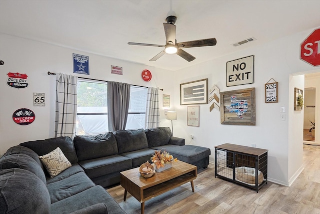 living room featuring ceiling fan and light hardwood / wood-style floors