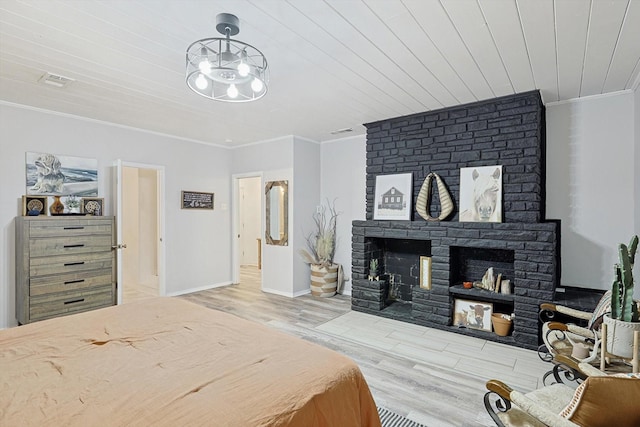 bedroom featuring ornamental molding, a fireplace, wooden ceiling, and light wood-type flooring