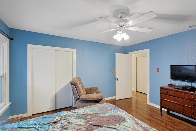 bedroom featuring wood-type flooring, a closet, and ceiling fan