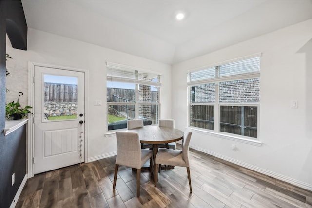 dining space with lofted ceiling and hardwood / wood-style floors