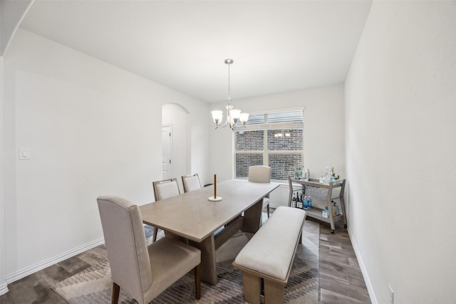 dining room with an inviting chandelier and dark hardwood / wood-style floors