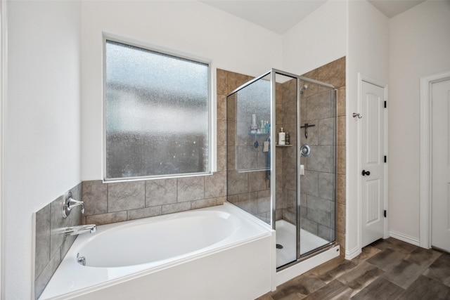 bathroom with plus walk in shower and hardwood / wood-style floors