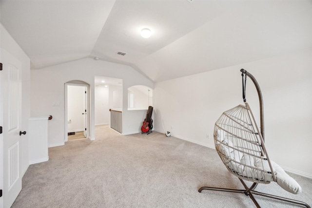 living area with light carpet and vaulted ceiling