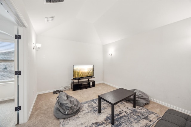 living area featuring vaulted ceiling and light colored carpet