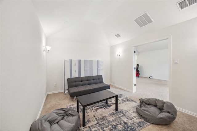 sitting room featuring lofted ceiling and light carpet