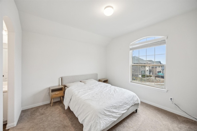 carpeted bedroom featuring lofted ceiling