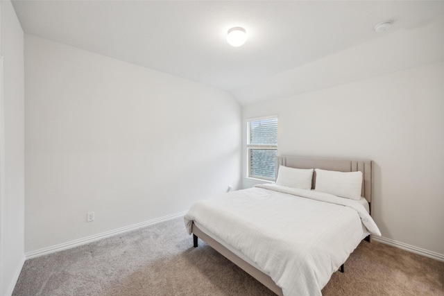 carpeted bedroom featuring lofted ceiling