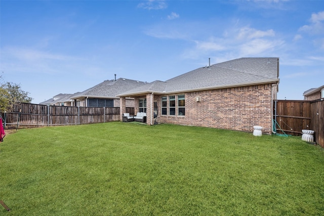 rear view of house with a yard and an outdoor hangout area