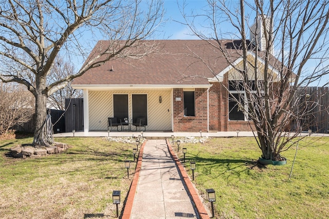 view of front of house featuring a patio and a front lawn